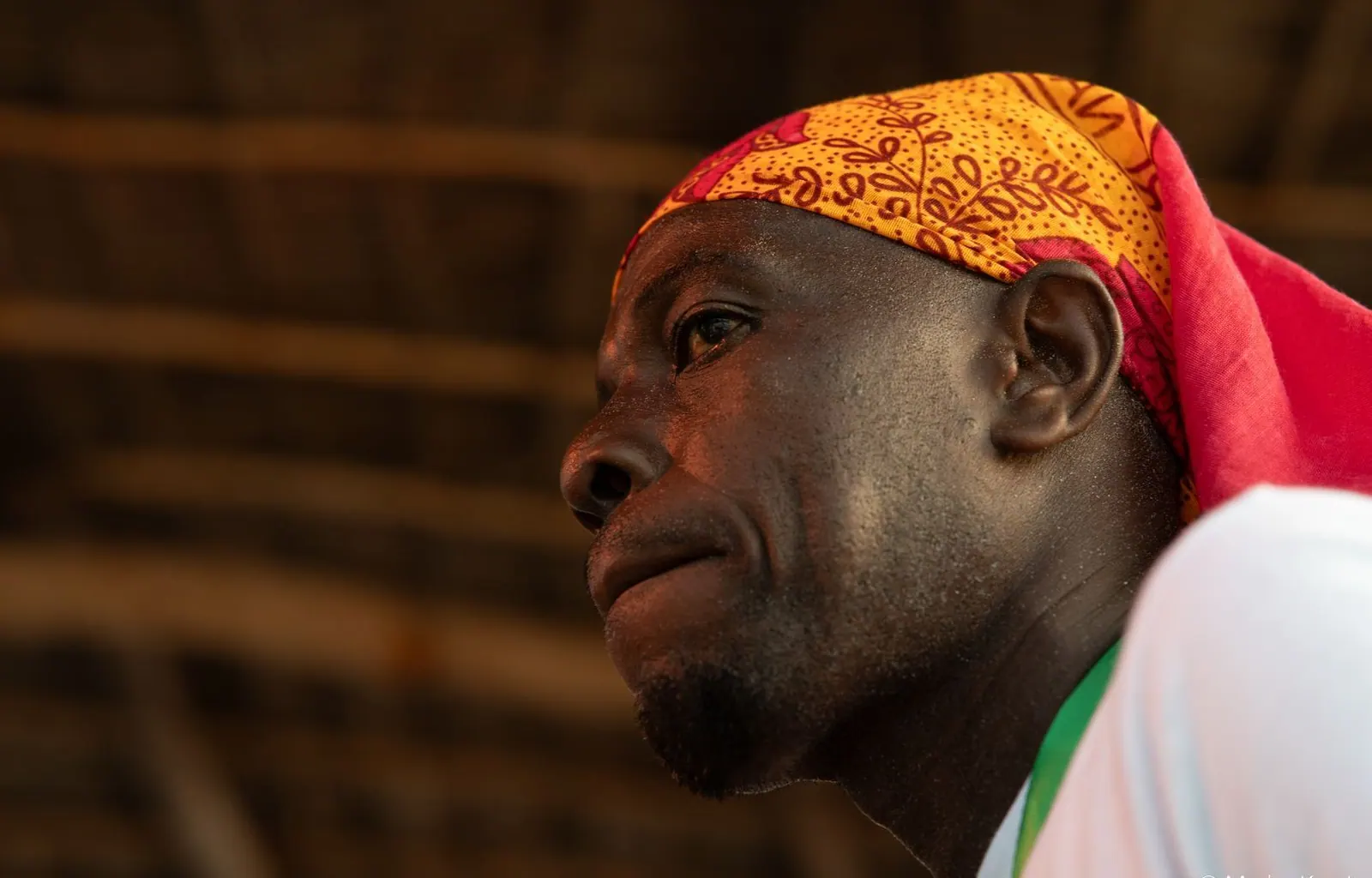 Performer in a red and orange headscarf, Kanga Fest 2025