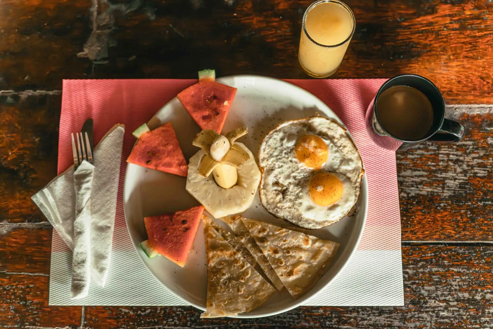 Breakfast from above: eggs, watermelon, pancake, juice and coffee