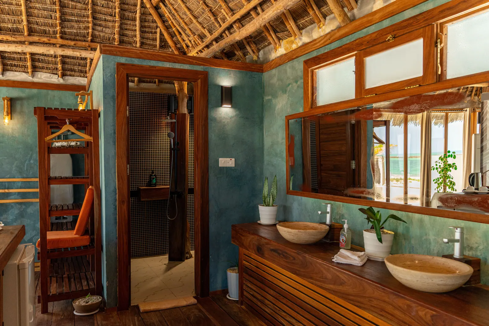 Open bathroom with twin stone basins and sea-green walls, Tiki Beach
